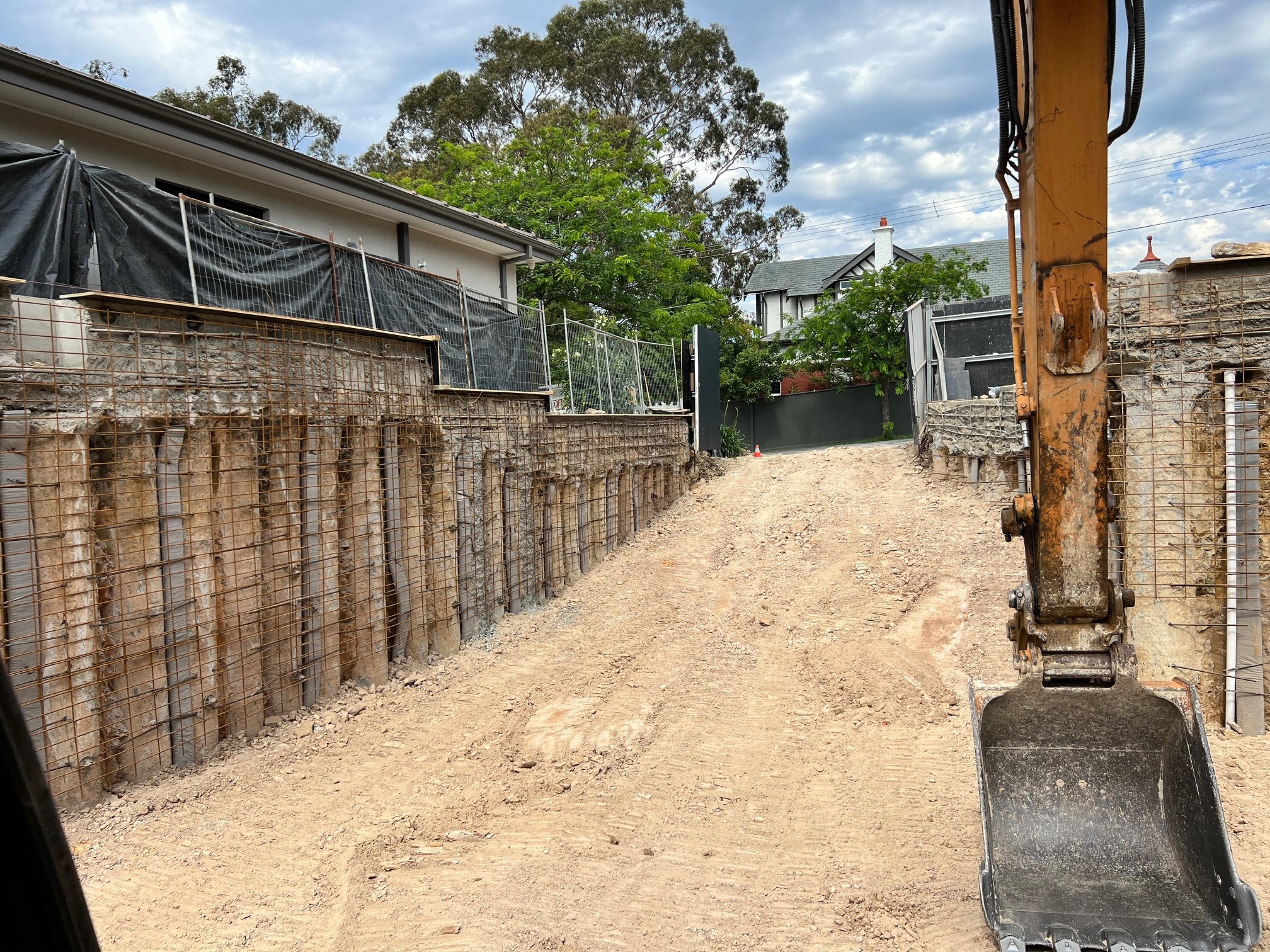 Inner Melbourne basement excavation with secant piling retaining walls and access ramp in constrained residential site