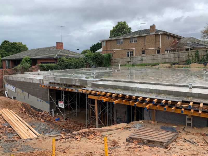 Residential suspended slab with orange timber formwork supporting concrete structure