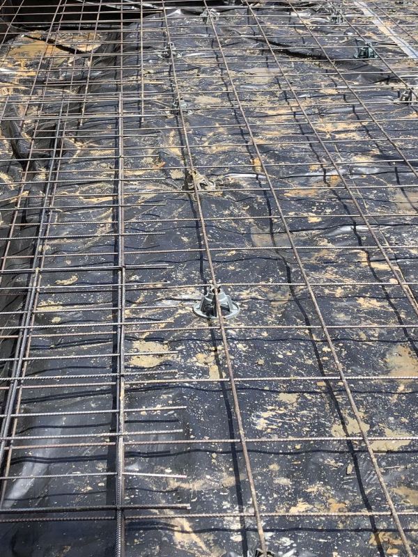 Detailed view of steel reinforcement mesh grid prepared for concrete slab construction with precise spacing and bar placement