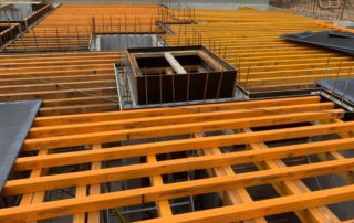 Orange timber formwork and structural beams demonstrating engineering design