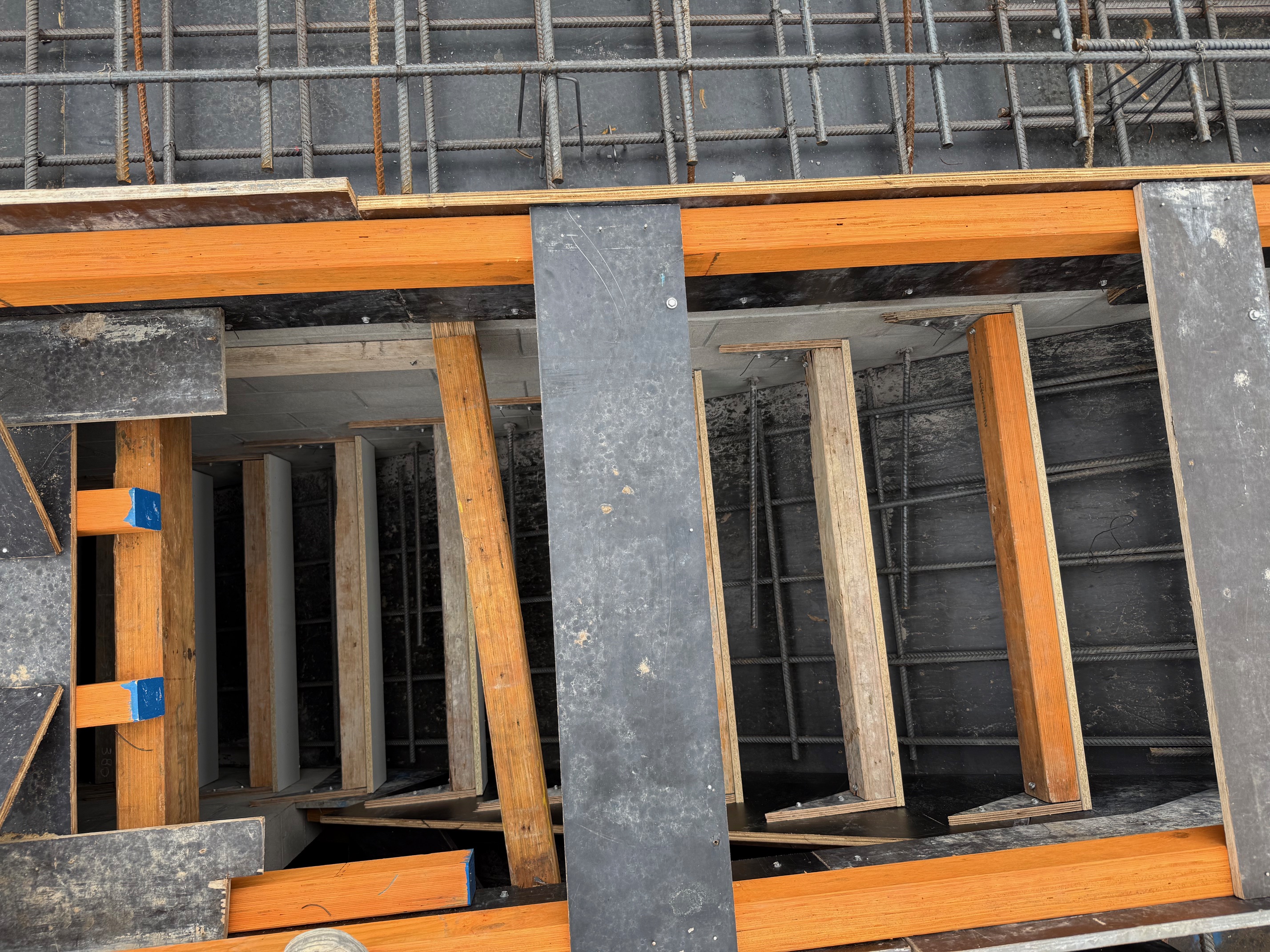 Reinforcement cage integration with basement formwork
